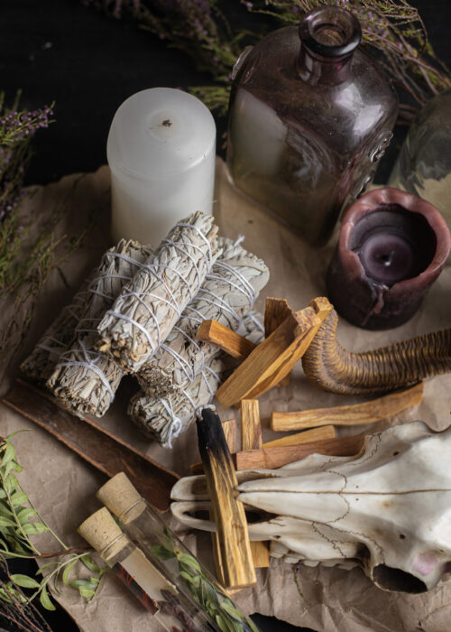 magical-occult-background-with-candles-incense-sticks-herbs-skull